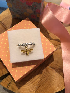 Gold bee charm with silver bead ring