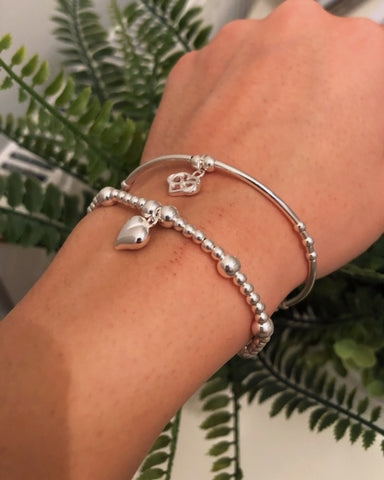 2 bracelet stack, solid heart and heart in hearts charm